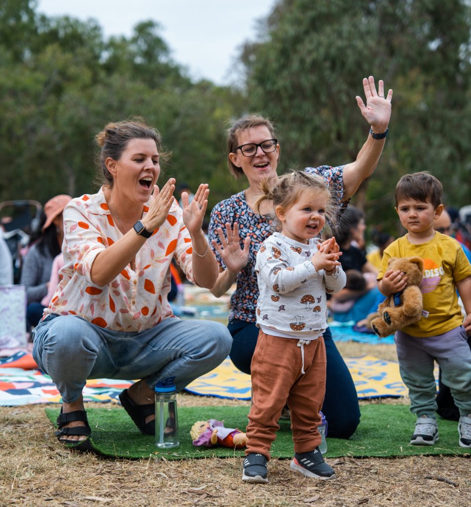 Mothers and their children playing and clapping together