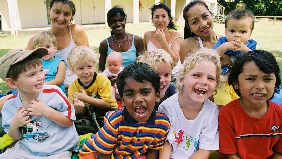 Children and their mothers smiling looking at the camera