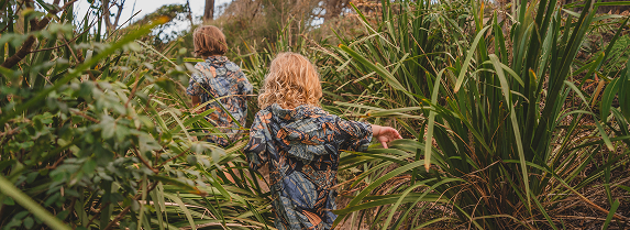 Children happily walking down a bush path together